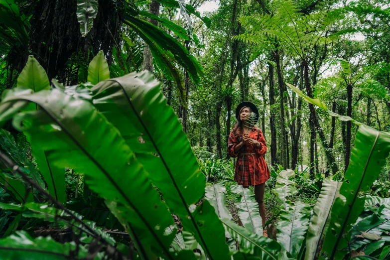 a woman standing in the middle of a forest, sumatraism, avatar image