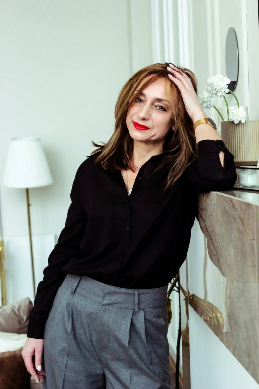 a woman standing in front of a mirror in a room, inspired by Lucia Peka, instagram, wearing a black shirt, as cristina kirchner, portrait image, wearing elegant casual clothes