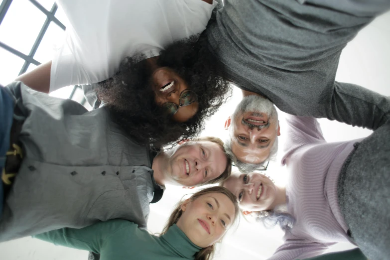 a group of people standing in a circle, looking up at camera, avatar image