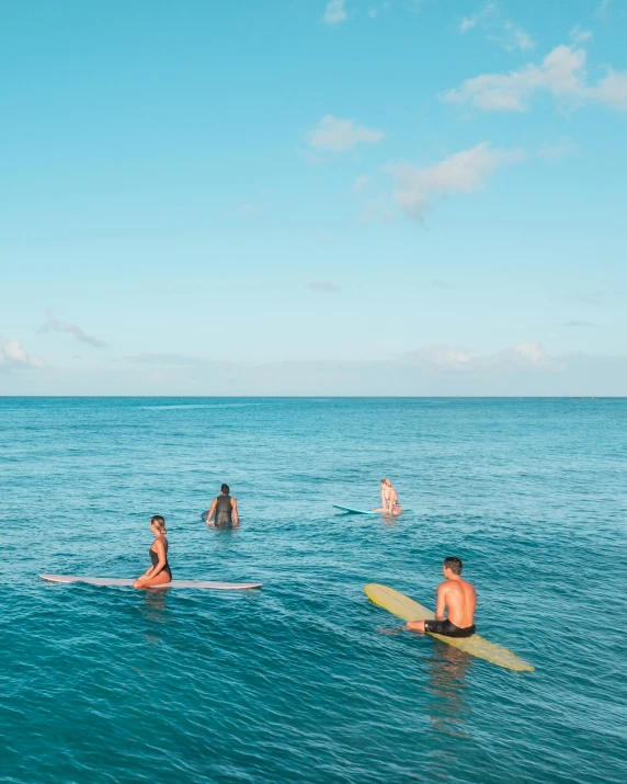 a group of people riding surfboards on top of a body of water, bottom of ocean, waikiki beach, on the ocean