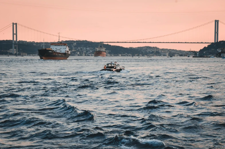 a boat in the water with a bridge in the background, pexels contest winner, happening, fallout style istanbul, wavy water, thumbnail, middle of the ocean