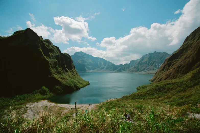 a large body of water surrounded by mountains, by Muggur, pexels contest winner, sumatraism, manila, 2000s photo, fan favorite, parks and lakes