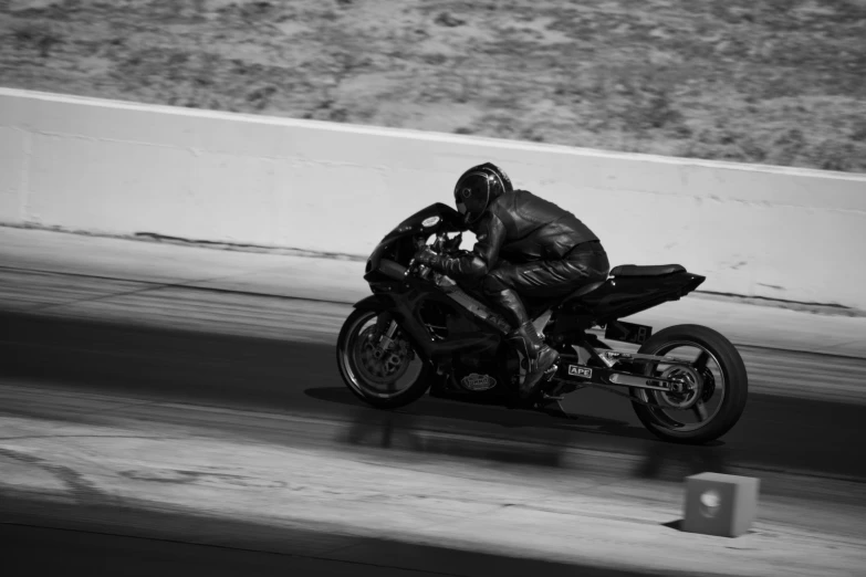 a black and white photo of a person on a motorcycle, by Tom Bonson, pexels contest winner, on a street race track, las vegas, 15081959 21121991 01012000 4k, stealth