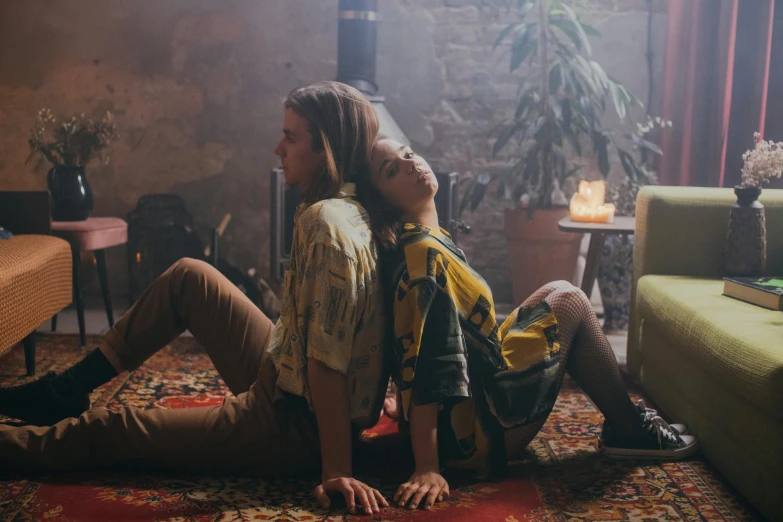 two people sitting on a rug in a living room, a portrait, by Emma Andijewska, trending on pexels, renaissance, jamie campbell bower, performing a music video, laying on their back, vintage glow