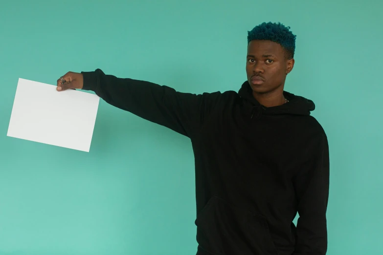 a man holding a piece of paper in his hand, pexels contest winner, black and teal paper, non binary model, lil uzi vert, striking a pose