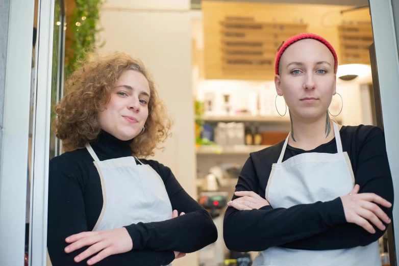 a couple of women standing next to each other, antipodeans, in a butcher shop, avatar image, portrait image, fzd school of design