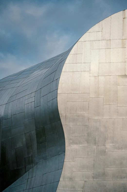 a close up of a building with a sky background, an abstract sculpture, curved body, silver，ivory, curvy build, grain”