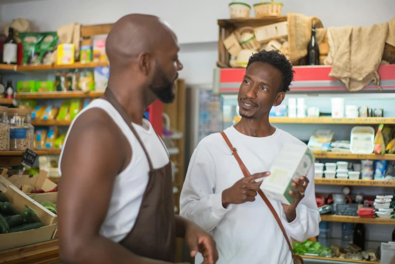 a couple of men standing next to each other in a store, pexels contest winner, renaissance, nubian, getting groceries, information, praised