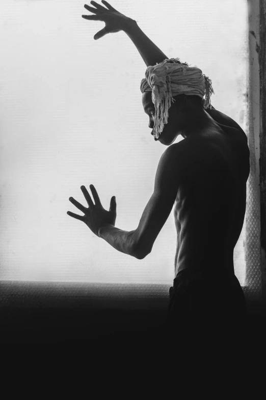 a man that is standing in front of a window, inspired by Gordon Parks, xxxtentacion, covered head, indistinct man with his hand up, 1996)