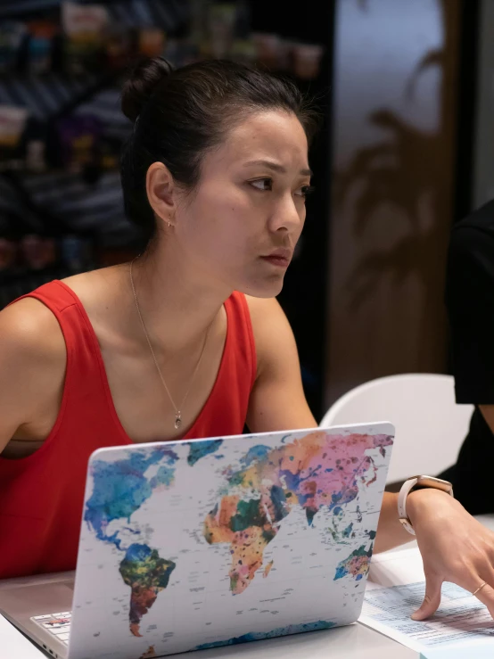 a couple of people sitting at a table with a laptop, inspired by helen huang, art & language, looking serious, close up shot from the side, woman holding another woman, teaching