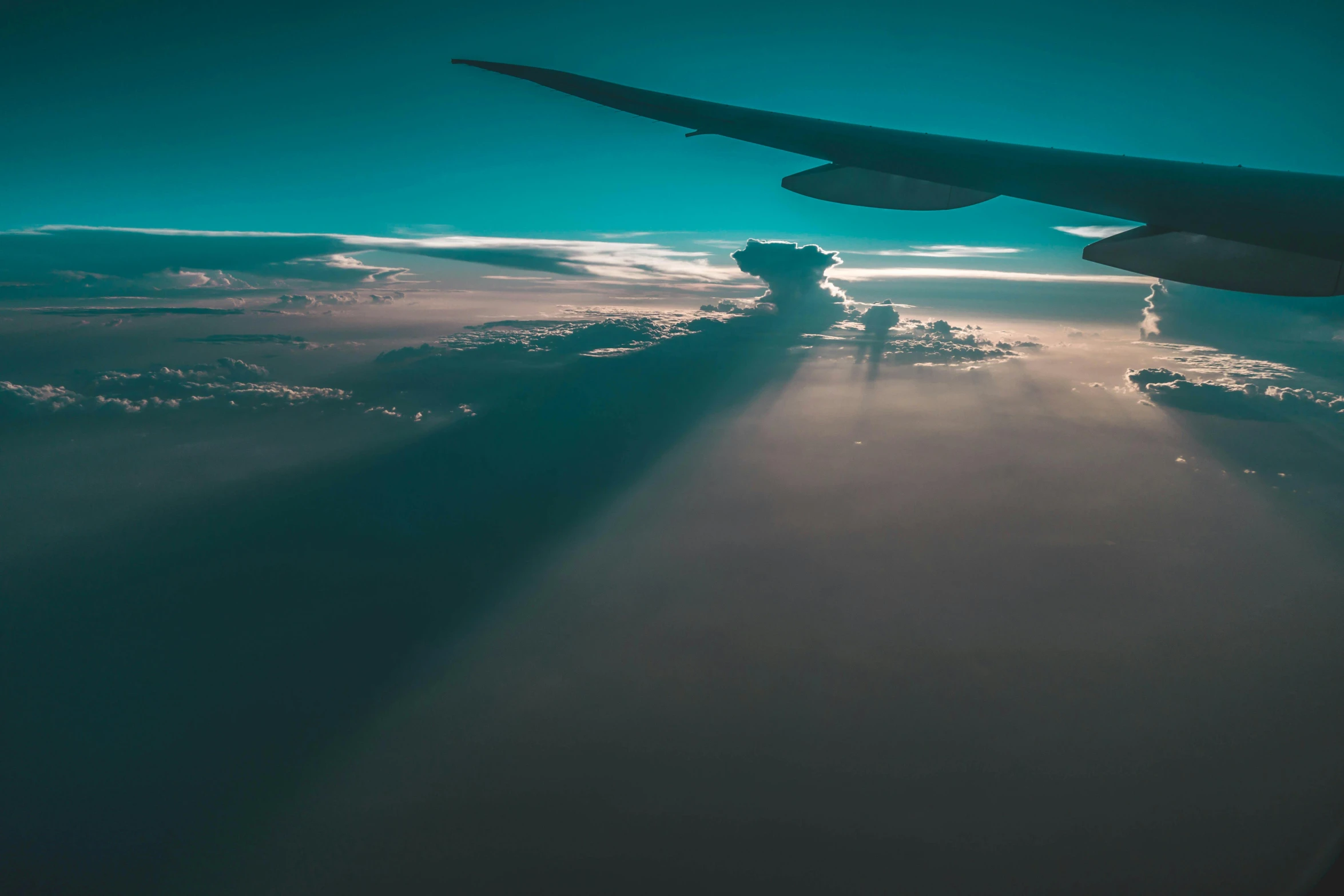 the wing of an airplane flying above the clouds, pexels contest winner, teal sky, lit from the side, thumbnail, runway