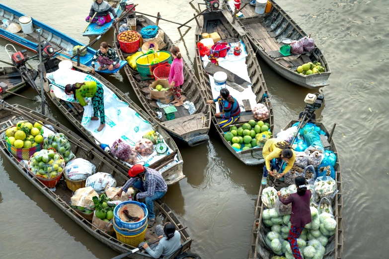 a group of boats filled with lots of fruit and vegetables, press shot, waterways, fan favorite, people shopping