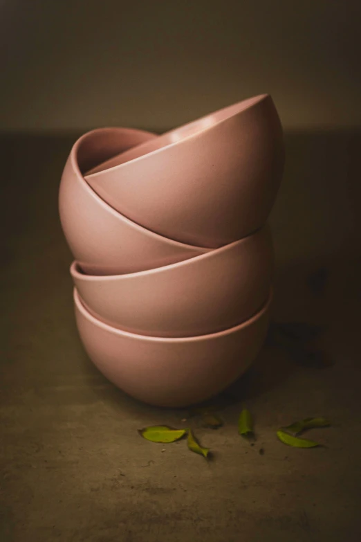 a stack of pink bowls sitting on top of a table, a still life, unsplash, curved. studio lighting, hero shot, matte fresco, eating