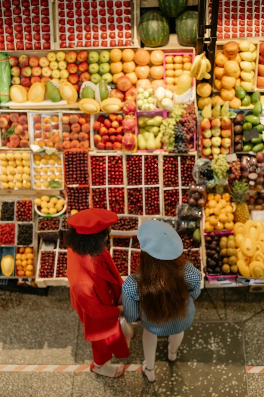 a couple of people standing in front of a fruit stand, by Julia Pishtar, trending on unsplash, panoramic view of girl, inspect in inventory image, red-yellow colors, square