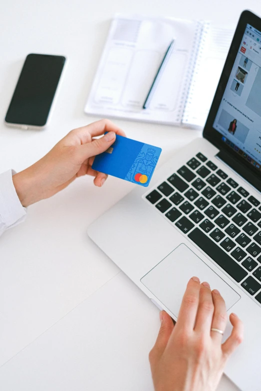 a person holding a credit card in front of a laptop, a computer rendering, pexels contest winner, chartreuse and orange and cyan, cover shot, no - text no - logo, photo for a store