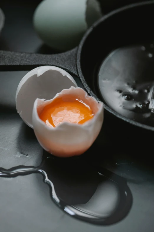 a close up of an egg in a pan on a table, cracks, innovation, paul barson, melted wax