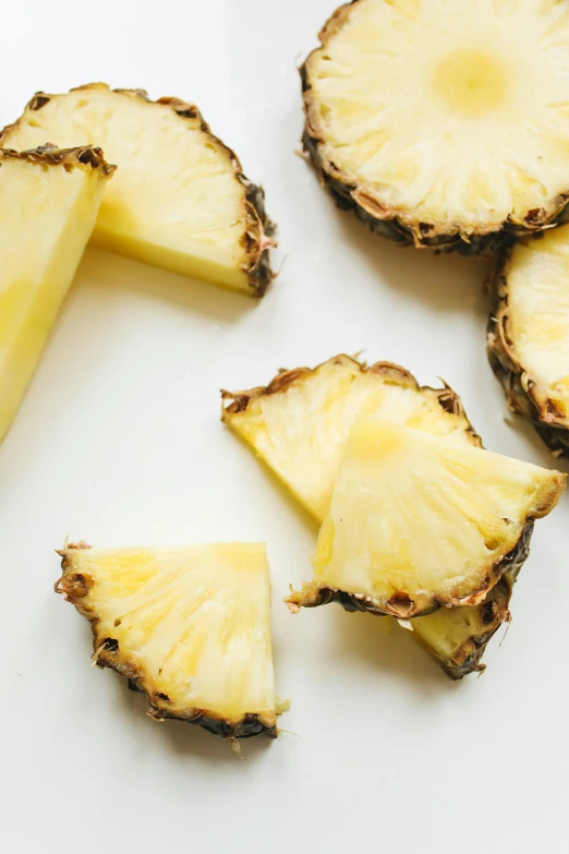 sliced pineapples on a white surface, fan favorite, crispy, f / 2 0, vanilla