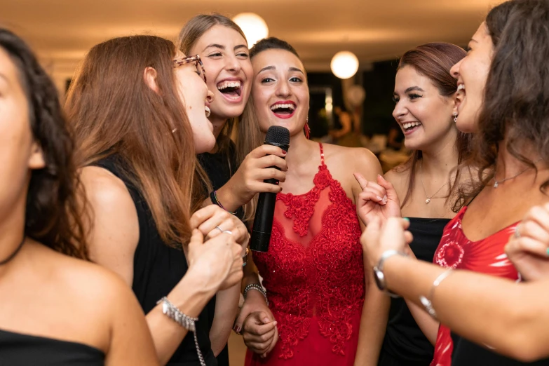 a group of women standing next to each other holding microphones, an album cover, by Julia Pishtar, shutterstock, happening, wearing red formal attire, at the party, flirting, youtube thumbnail