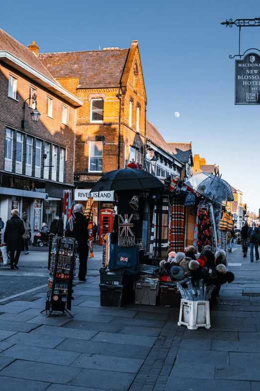 a group of people walking down a street next to tall buildings, arts and crafts movement, warwick saint, lots of signs and shops, today\'s featured photograph 4k, city street on the moon