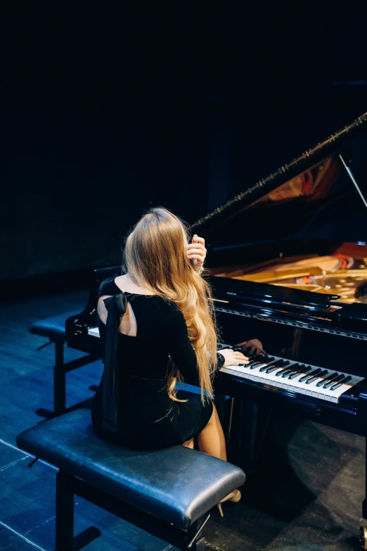 a woman sitting on a bench next to a piano, performing on stage, profile image, blonde, infp young woman