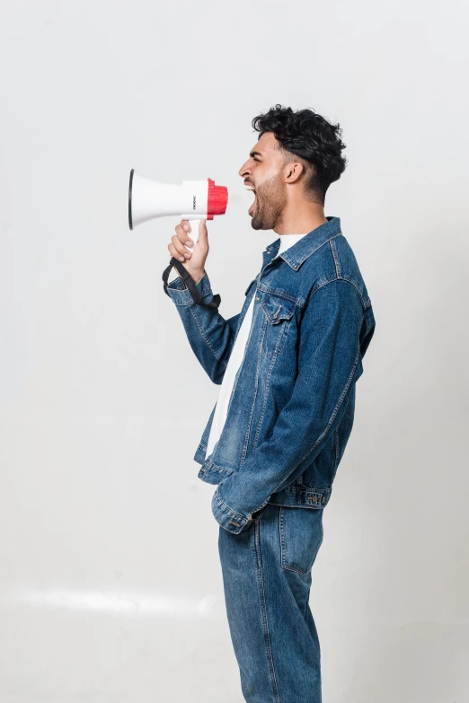 a man with a megaphone in his hand, a picture, pexels, wearing a shirt and a jean, profile image, clean background trending, headshot profile picture