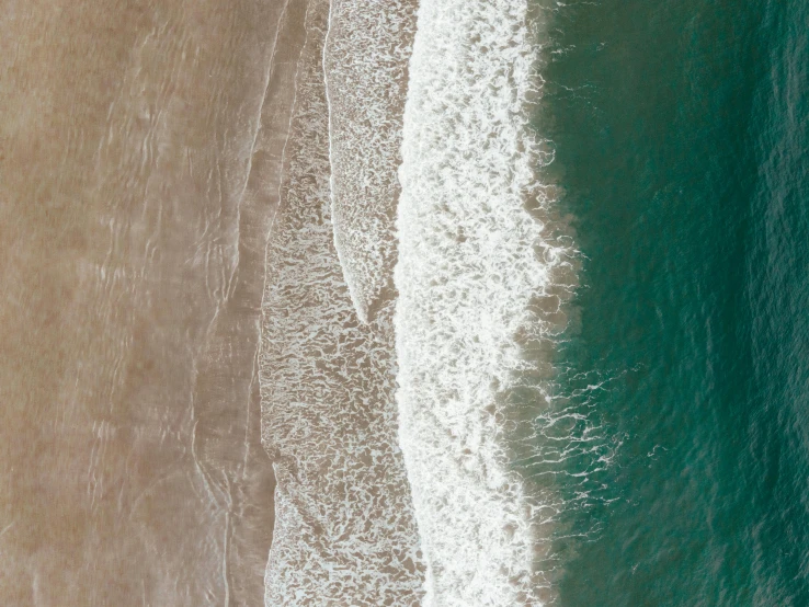 a person riding a surfboard on top of a sandy beach, by Neil Blevins, pexels contest winner, minimalism, extremely detailed water texture, aerial, currents, vertical wallpaper