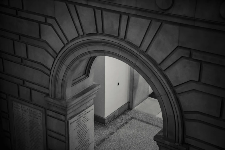 a black and white photo of a doorway in a building, inspired by Sydney Prior Hall, unsplash contest winner, back arched, museum photograph, viewed from bird's-eye, stone relief