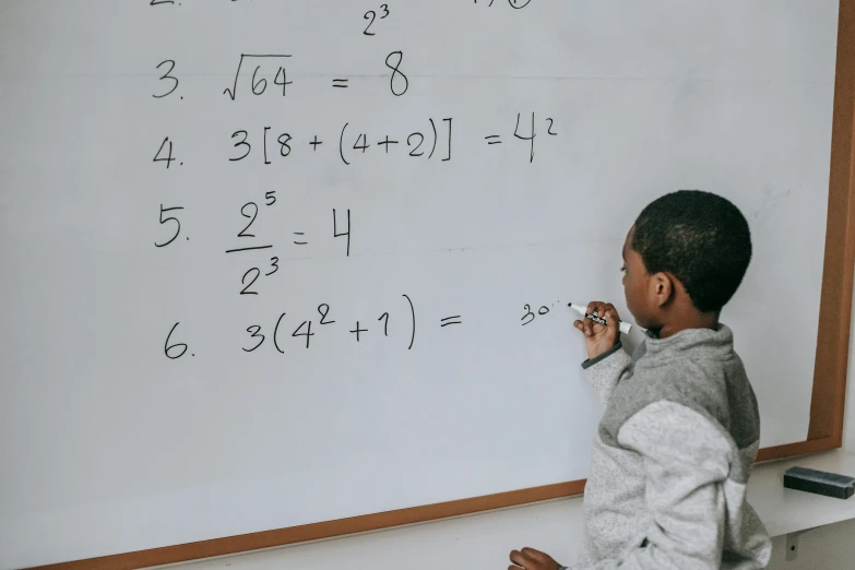 a young boy writing on a white board, by Carey Morris, pexels, equations, black teenage boy, gif, fibonacci sequence