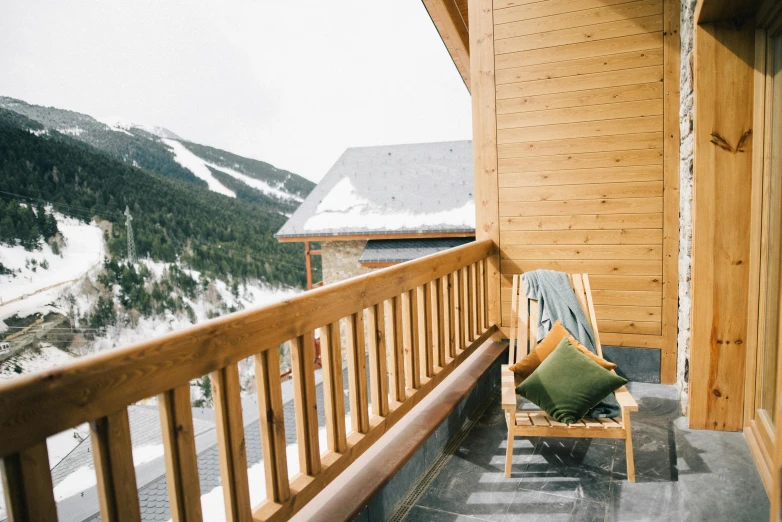 a chair on a balcony with mountains in the background, winter vibes, arrendajo in avila pinewood, chalet, slide show