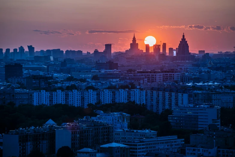 the sun is setting over a large city, pexels contest winner, socialist realism, russian architecture, skyline showing, hasbulla magomedov, multiple suns