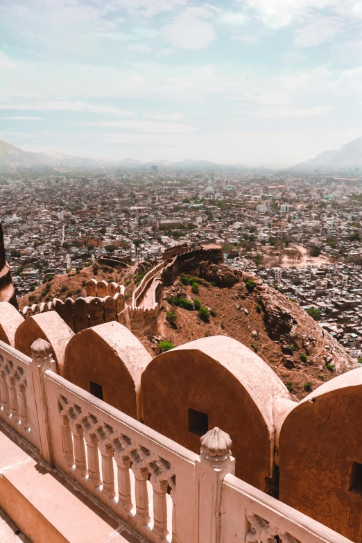 a woman standing at the top of a hill overlooking a city, pexels contest winner, arabesque, inside a palace, mogul khan, panoramic, 35mm photo