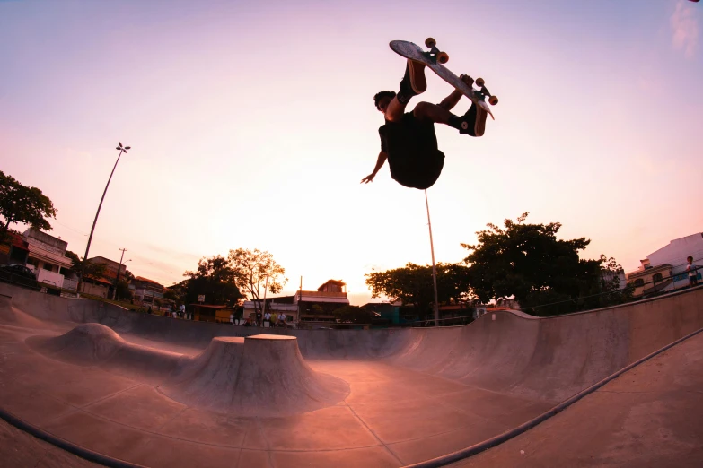 a man flying through the air while riding a skateboard, a picture, by Carey Morris, unsplash contest winner, evening at dusk, ultrawide lens, skatepark, manly