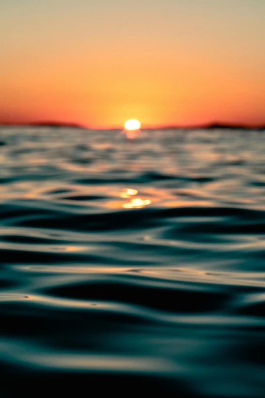 the sun is setting over a body of water, pexels, honey ripples, deep depth of focus, endless, wavy