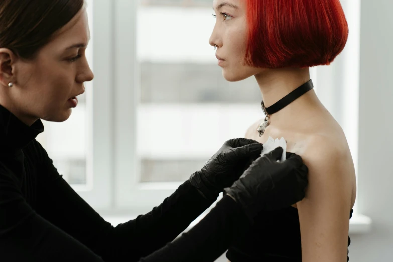 a woman putting a choke on another woman's neck, a tattoo, by Gavin Hamilton, trending on pexels, renaissance, holding a syringe, black and red silk clothing, on a white table, profile image