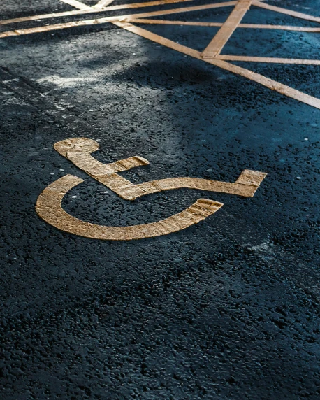 a handicap sign on the floor of a parking lot, trending on pexels, graffiti, lgbt, background image, stitches, alessio albi