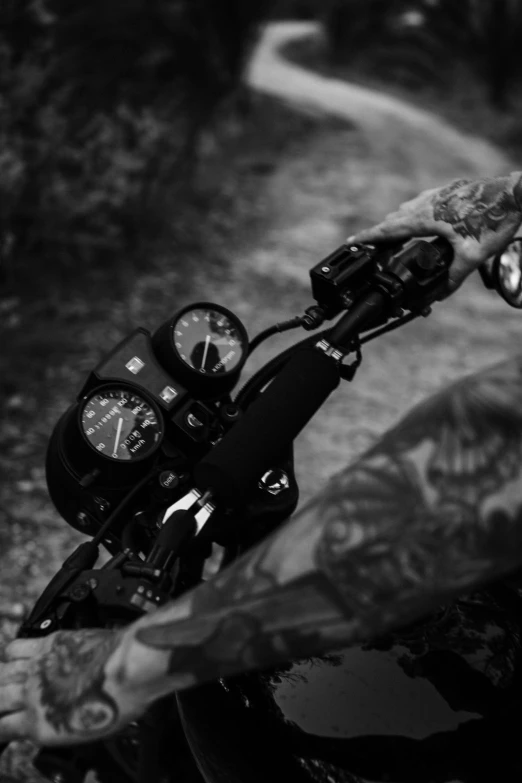 a man riding a motorcycle down a dirt road, a black and white photo, inspired by Alex Petruk APe, dials, closeup!!!!!!, horns with indicator lights, abandoned vibes