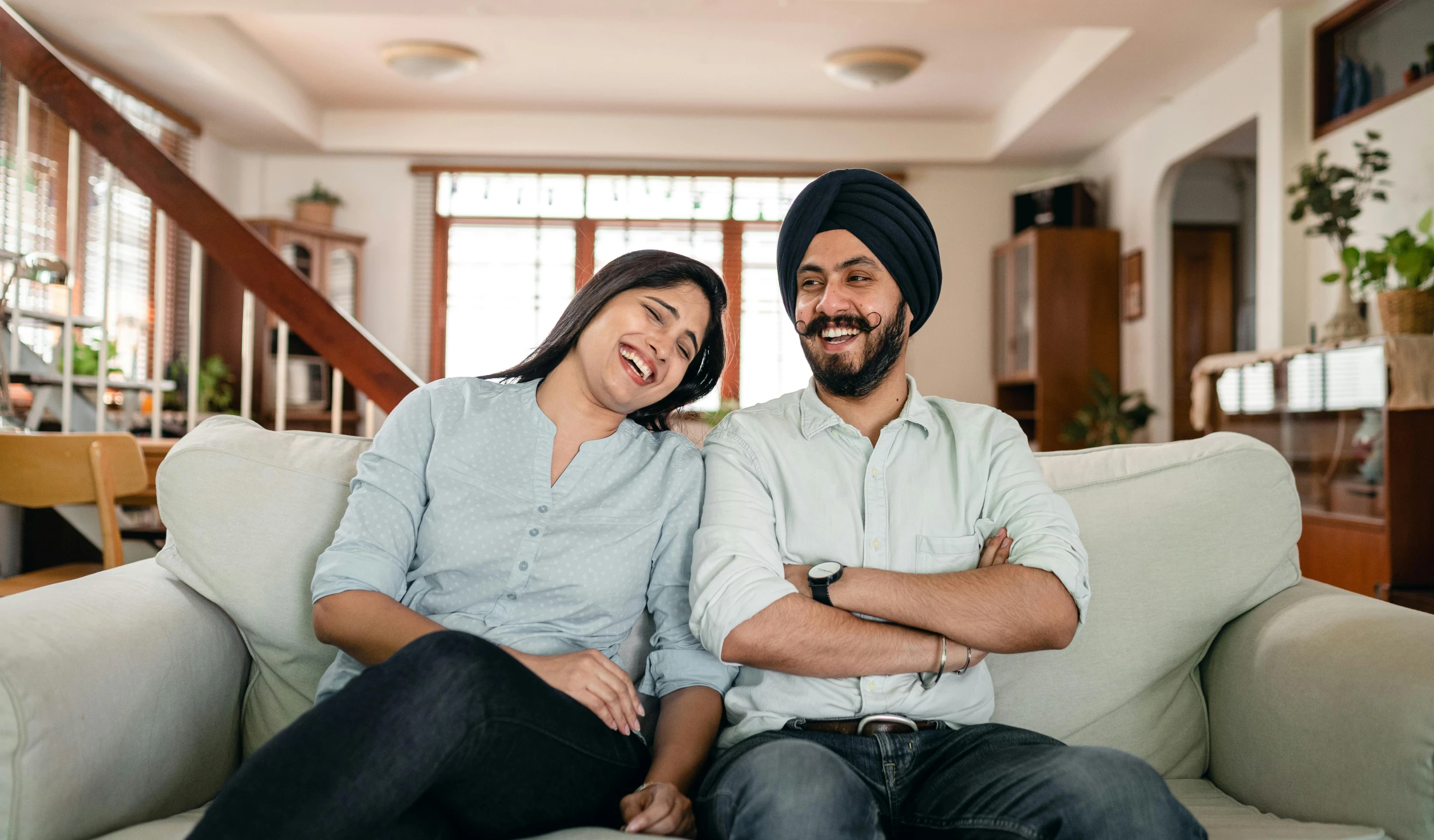 a man and a woman sitting on a couch, inspired by Manjit Bawa, pexels contest winner, smiling expression, australian, avatar image, fertility