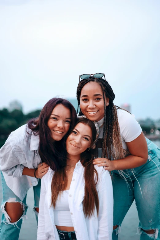 a group of young women standing next to each other, a picture, trending on unsplash, three heads, rooftop, mixed race, slide show