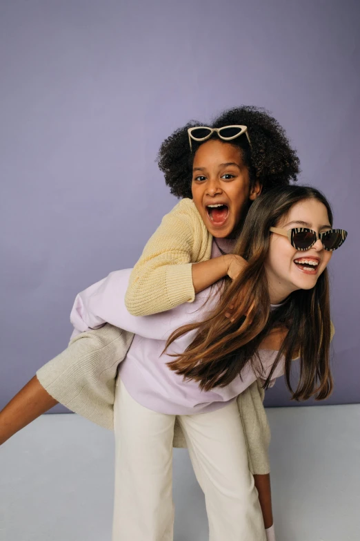 a woman carrying a little girl on her back, trending on pexels, incoherents, wearing shades, lilac, two models in the frame, diverse outfits