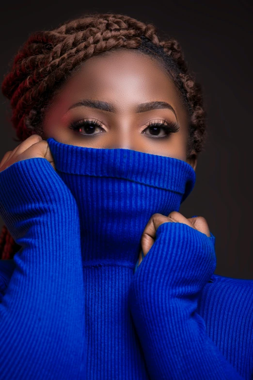 a woman wearing a blue turtle neck sweater, an album cover, inspired by Chinwe Chukwuogo-Roy, trending on pexels, sweet eyes, fashion pose, uncropped, hiding