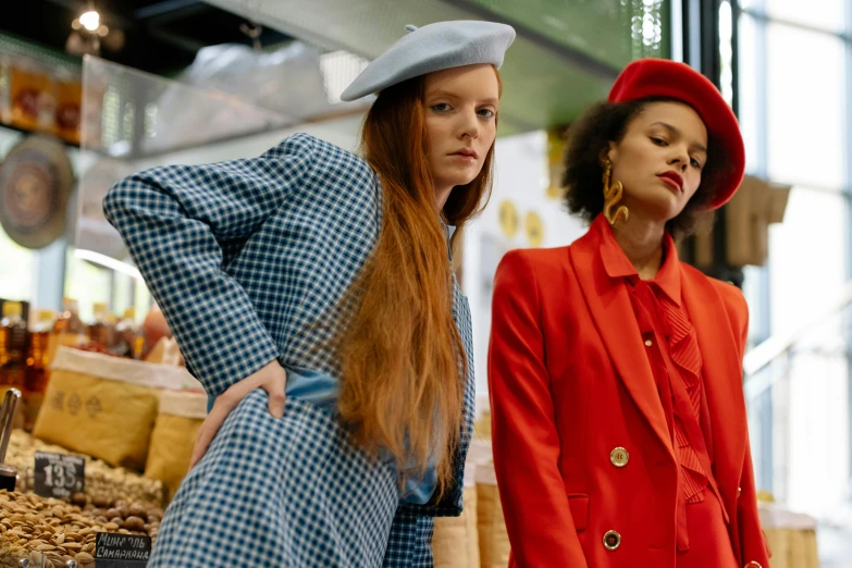 a couple of women standing next to each other, trending on pexels, renaissance, red hat, thom browne, sadie sink, people shopping