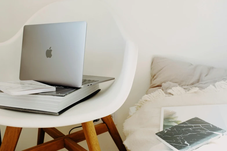 a laptop computer sitting on top of a white chair, by Carey Morris, trending on unsplash, small and cosy student bedroom, apple design, white background”, multiple stories