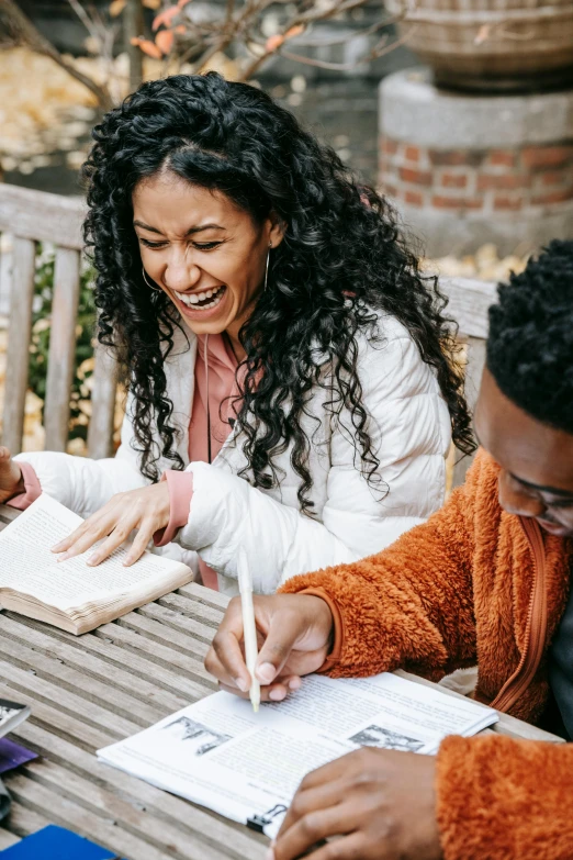 a group of people sitting around a wooden table, pexels contest winner, academic art, having fun in the sun, studying, both laughing, medium shot of two characters