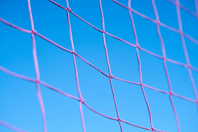a close up of a tennis net with a blue sky in the background, by Julian Allen, net art, pink background, soccer, blue and purple colour scheme, thumbnail