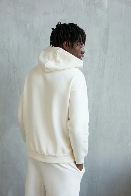 a man standing in front of a wall wearing a white hoodie, back view », off - white, wearing a hoodie and sweatpants, profile image