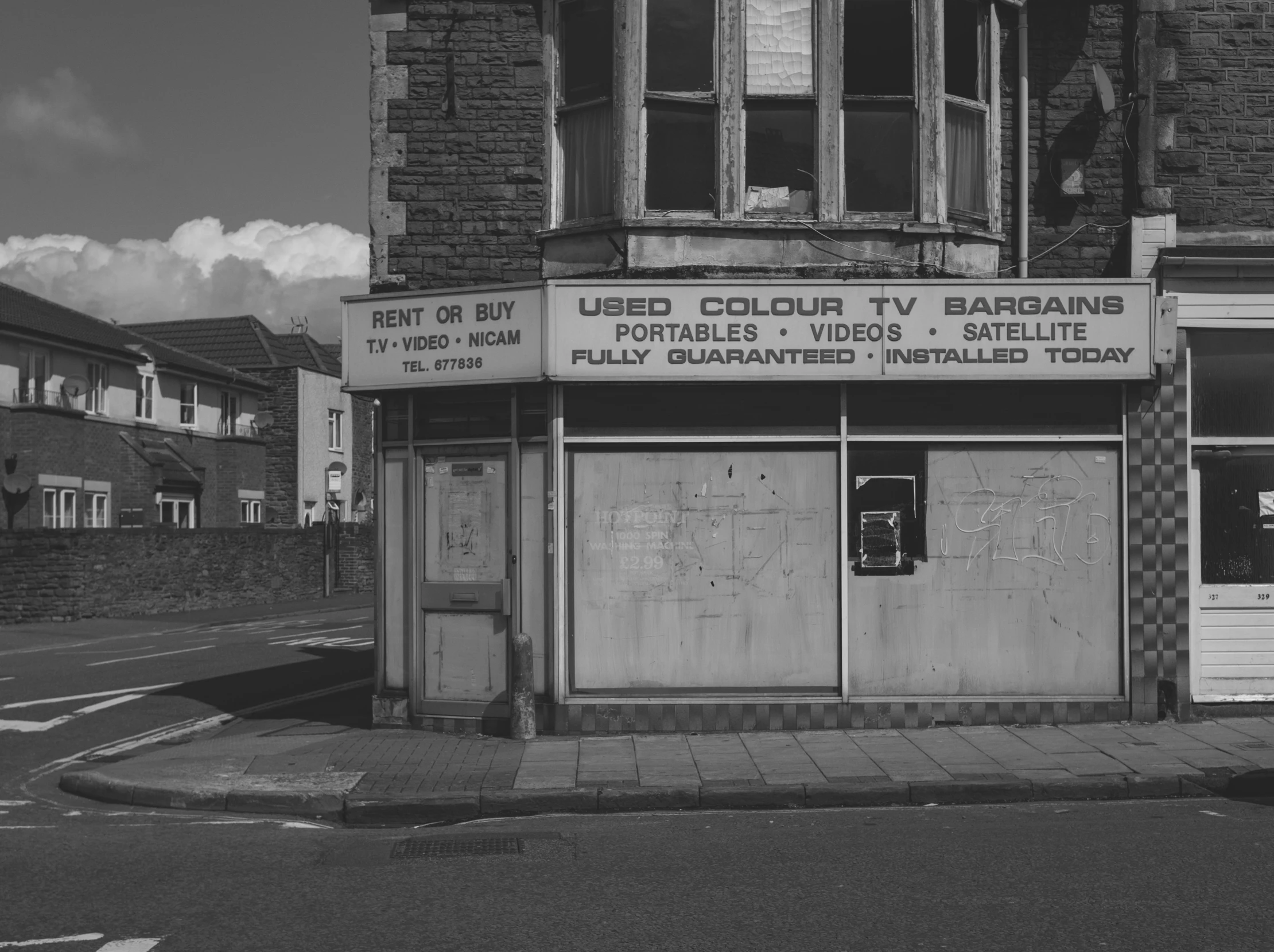 a black and white photo of a store front, by Lee Loughridge, unsplash, out worldly colours, nobody living there, wales, government archive photograph