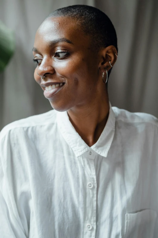 a close up of a person wearing a white shirt, by Dulah Marie Evans, earing a shirt laughing, short slicked - back hair, wearing a linen shirt, orisha