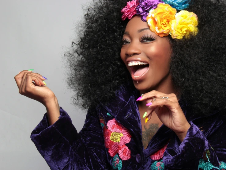 a woman with a flower in her hair, trending on pexels, afrofuturism, laughing out loud, sza, colorful clothes, professional modeling