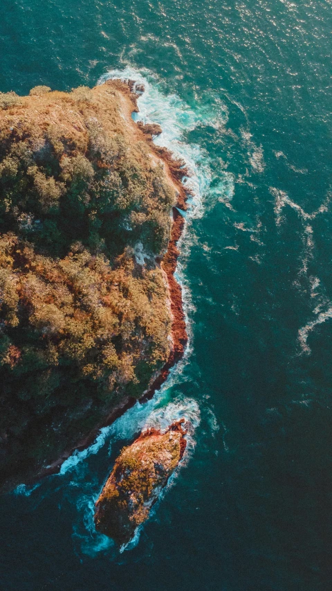 a small island in the middle of the ocean, pexels contest winner, australian bush, brown and cyan color scheme, torrent, full frame image