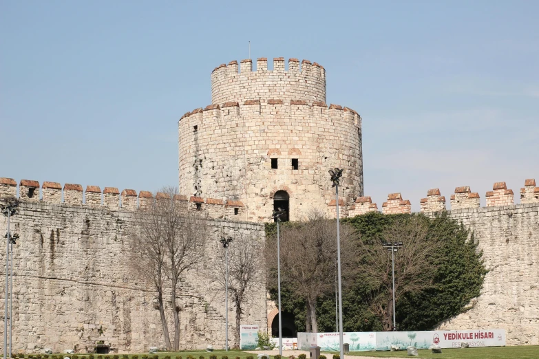 a large stone castle sitting on top of a lush green field, hurufiyya, the fall of constantinople, view from the streets, thumbnail